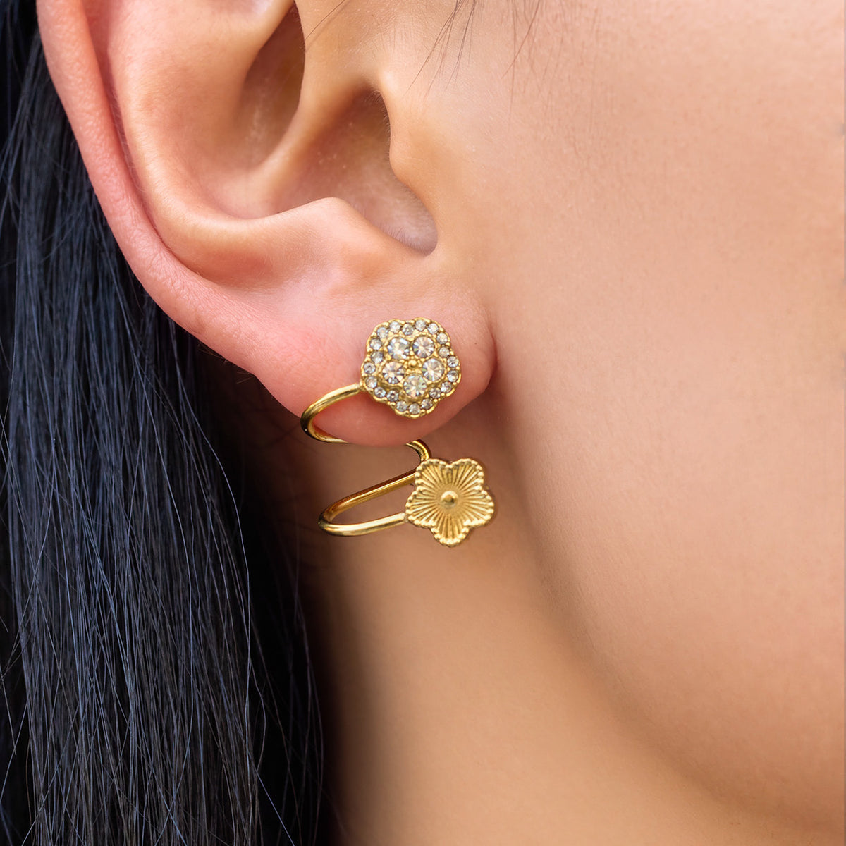 Side view of gold spiral flower ear cuff showing the sculptural non-pierced fit around the ear