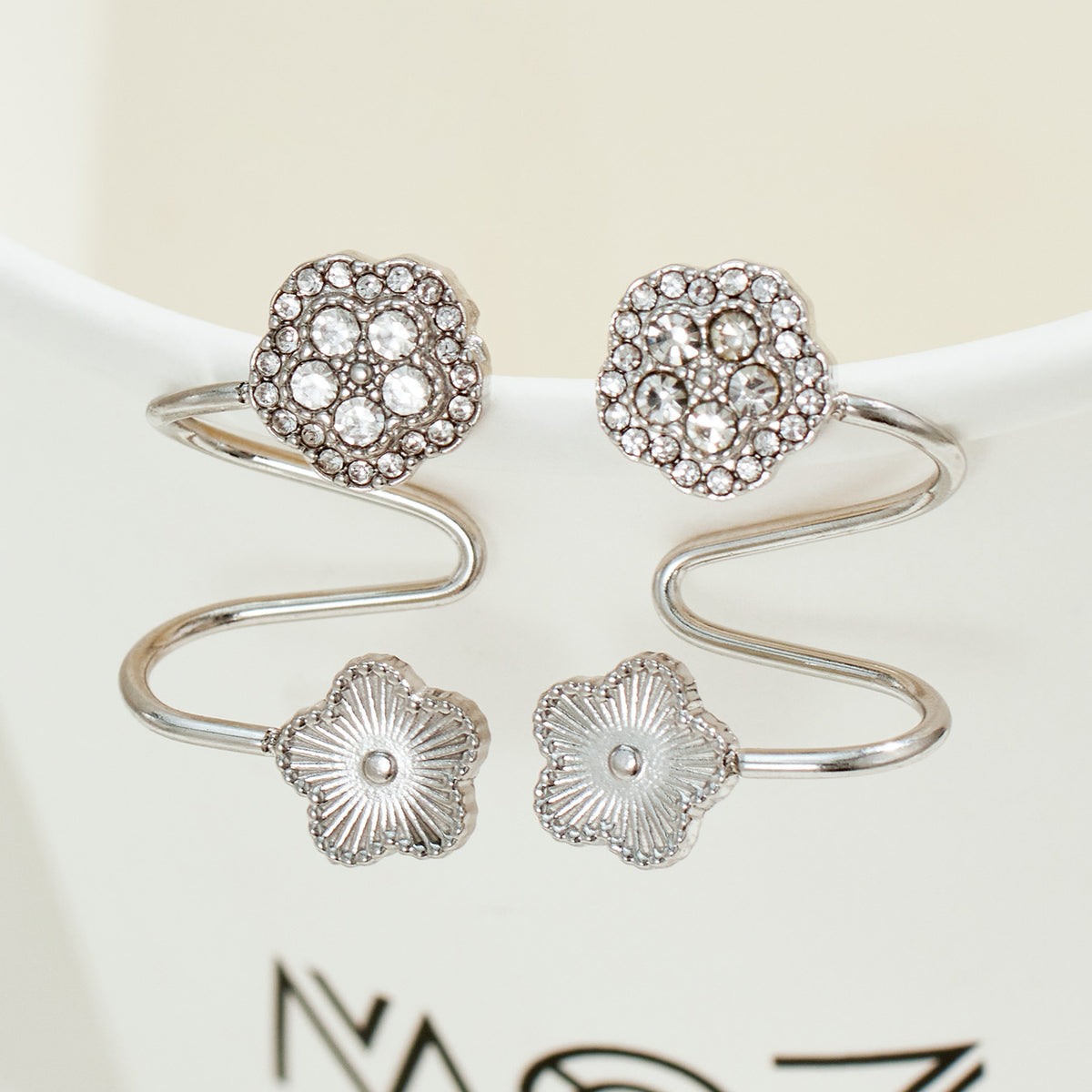 Silver stainless steel flower ear cuff with clear zircon detail and non-pierced spiral silhouette
