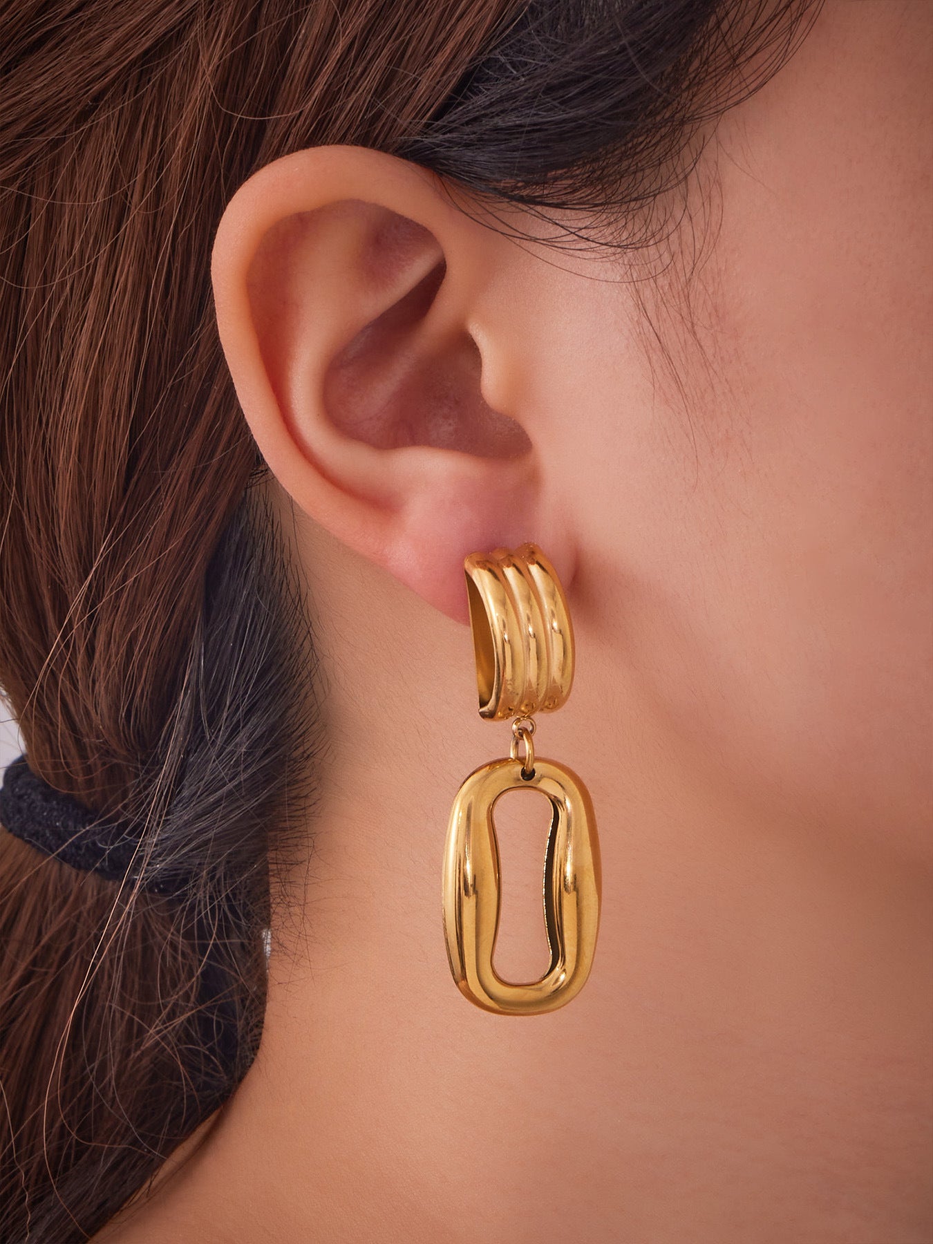 F475 gold hollow rectangle stainless steel door knocker earrings worn by model
