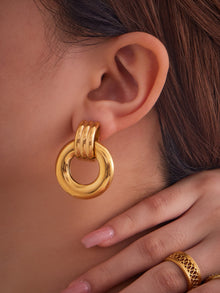 F476 gold compact round stainless steel door knocker earrings worn by model