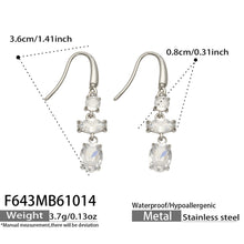 Size diagram of silver-tone three-stone fishhook earrings showing the hanging length, hook and clear oval stone dimensions