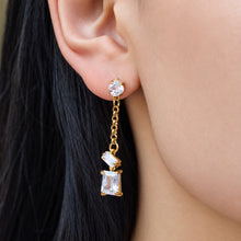 Model wearing clear zircon drop earrings with gold-tone linked details for an elegant everyday statement look
