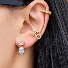 Model wearing clear zircon drop earrings with a two-stone marquise and teardrop silhouette