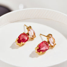Red teardrop zircon drop earrings displayed on a white jewelry tray with pink marquise top stones