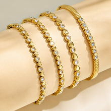 Four gold geometric zircon bangle designs displayed side by side