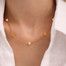 Close-up of a model wearing a freshwater pearl clover necklace with a delicate gold-tone chain