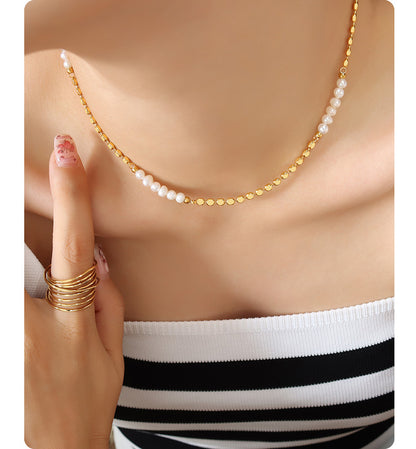 Model wearing freshwater pearl gold necklace with blazer for minimalist office jewelry and boutique gift displays