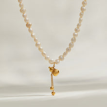 Freshwater pearl pendant necklace with gold charm front view