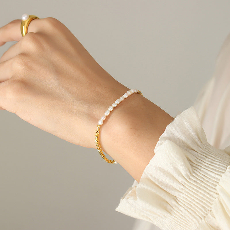 Model wearing a freshwater pearl stainless steel toggle clasp bracelet on the wrist