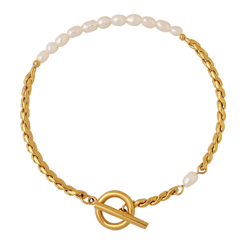 Freshwater pearl stainless steel bracelet with gold tone chain and toggle clasp on white background