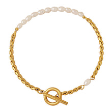 Freshwater pearl stainless steel bracelet with gold tone chain and toggle clasp on white background