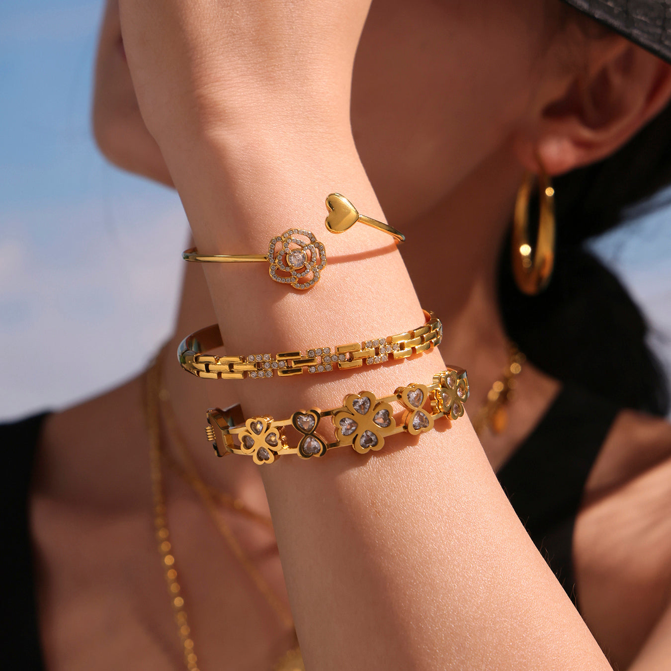 Close-up of 5A zircon full diamond heart rose thin open bangle on wrist, luxury fashion style