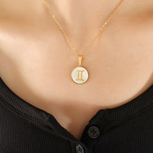 Gemini zodiac sign necklace worn by woman