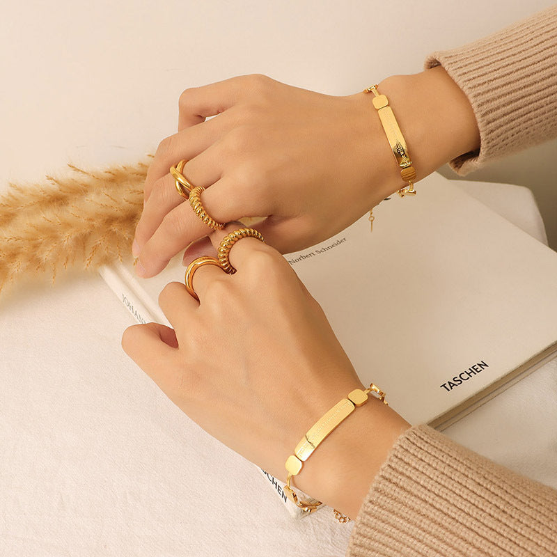 Close-up of a geometric stainless steel chain bracelet worn on the wrist