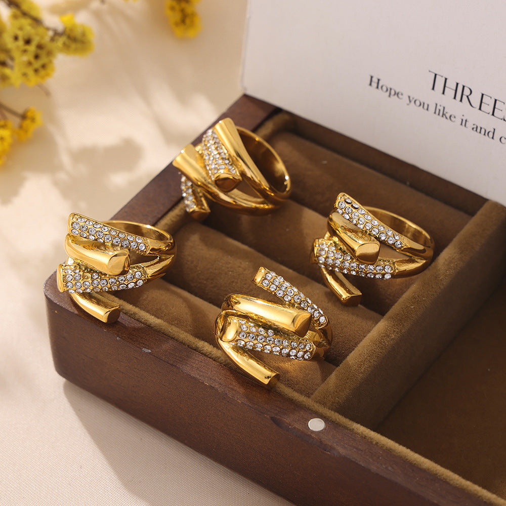 Gold cubic zirconia stainless steel rings arranged as a fashion jewelry collection
