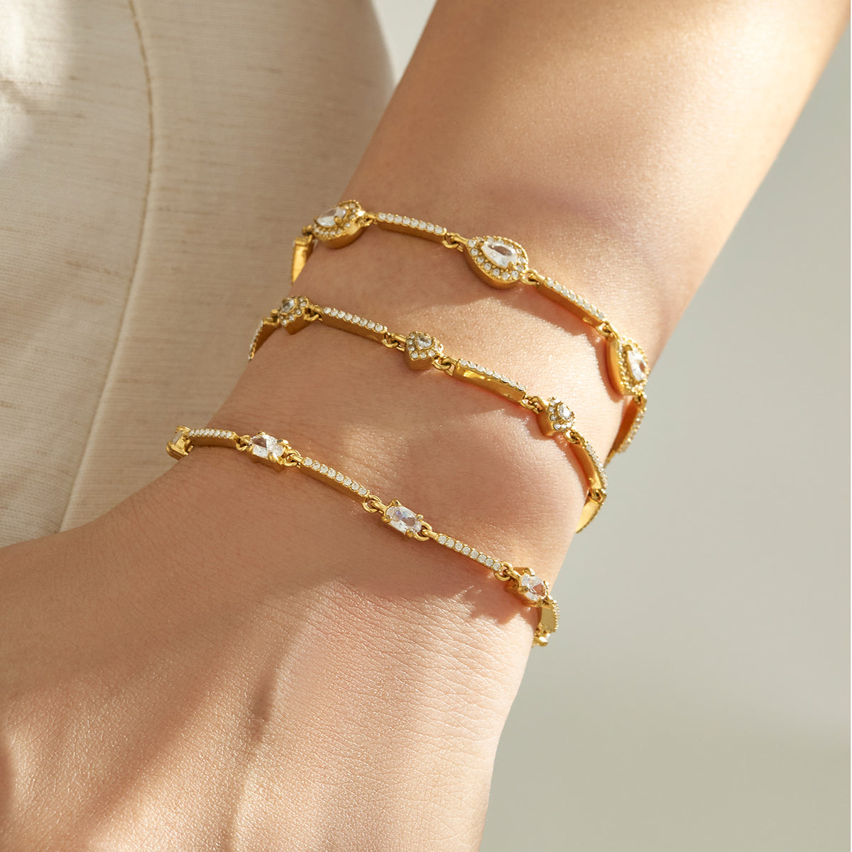 Gold geometric zircon bracelet stack featuring three coordinating center designs