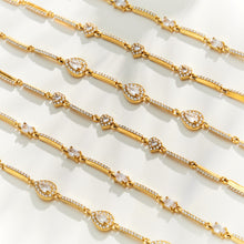 Gold zircon bracelets arranged in rows showing repeating stone details and delicate chain construction