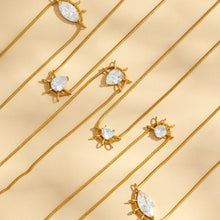 Assorted geometric zircon pendant necklaces arranged diagonally on a beige background
