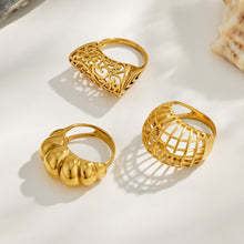 Three gold tone 316L stainless steel rings in sculptural hollow and cage statement designs