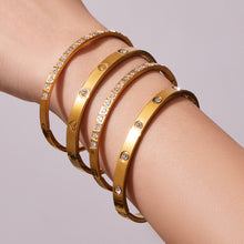 Gold bangle bracelet stack featuring multiple slim minimalist designs