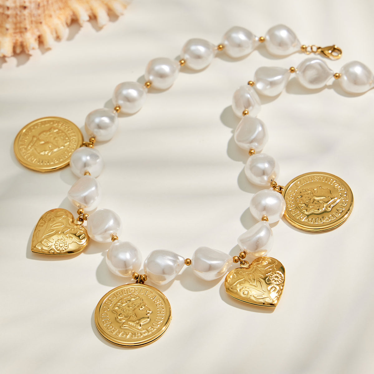 Gold beaded heart necklace with coin and heart charm details