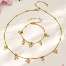 Gold butterfly charm necklace and bracelet assortment displayed on a neutral background