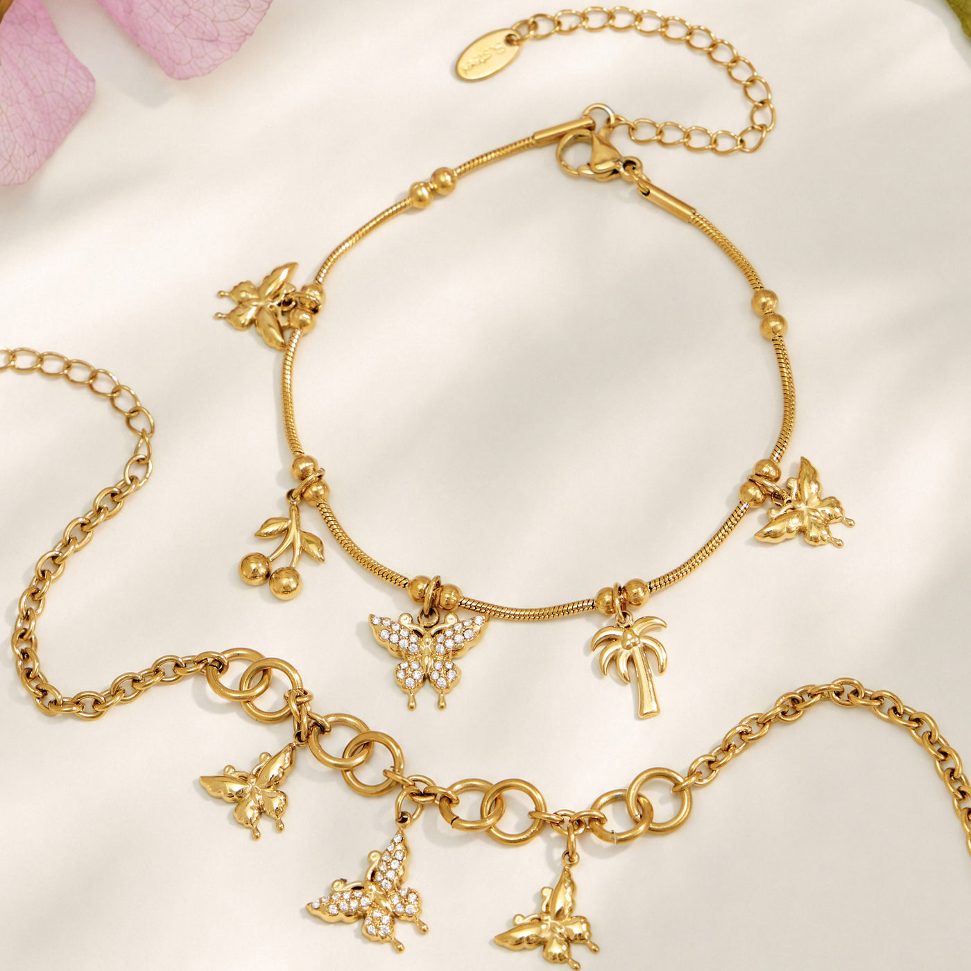 Gold butterfly charm necklace and coordinating bracelet displayed together