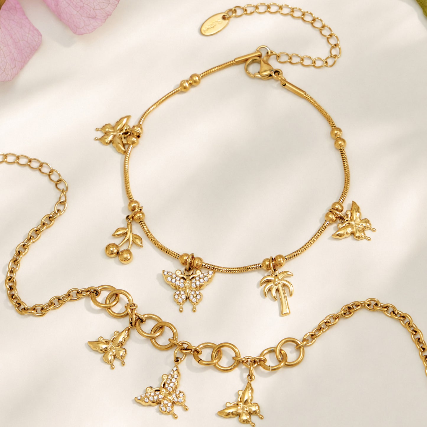 Gold butterfly charm necklace and coordinating bracelet displayed together
