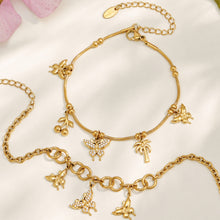 Gold butterfly charm necklace and coordinating bracelet displayed together