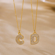 Gold C and D iced out initial letter necklaces with zircon pave pendants for personalized boutique jewelry