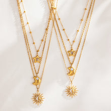 Gold-tone celestial layered necklaces displayed together with fine chains