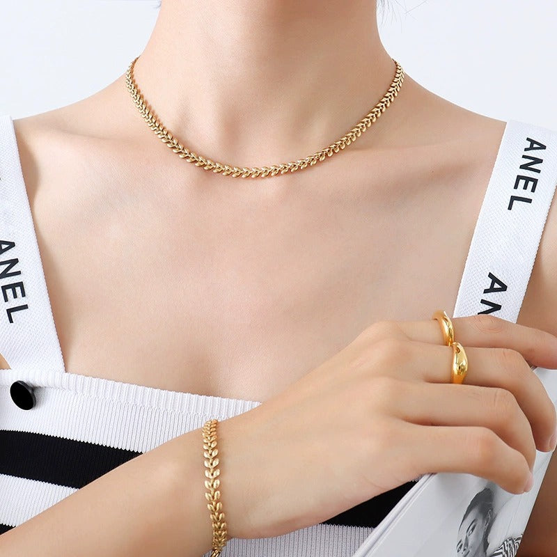 Model wearing gold chain bracelet with everyday outfit for giftable boutique bracelet styling