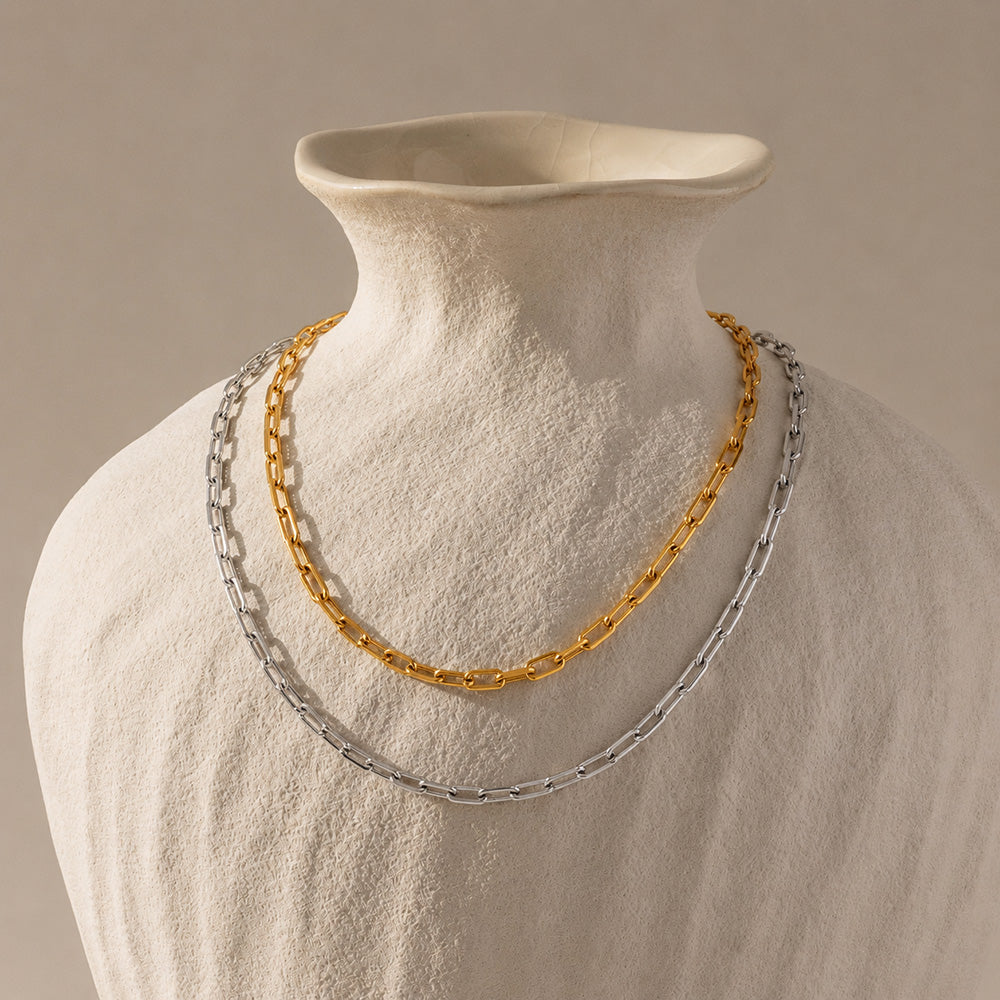 Gold stainless steel chain necklace displayed on a jewelry bust for wholesale presentation