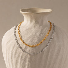 Gold stainless steel chain necklace displayed on a jewelry bust for wholesale presentation