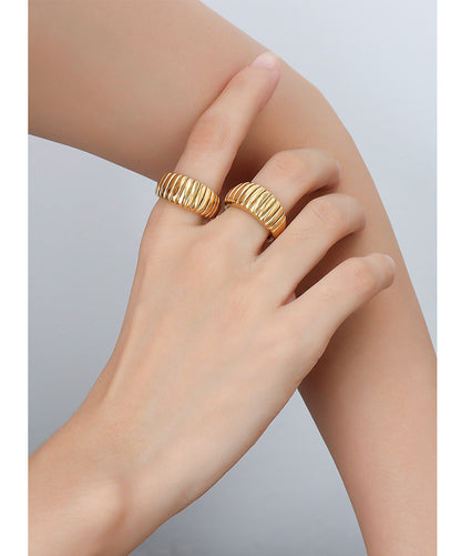 hand.jpg
Gold croissant ribbed dome rings stacked on hand with chunky wide band texture for French style ring displays