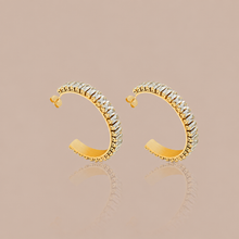 Gold C-shaped cubic zirconia hoop earrings with clear pavé-style stone setting
