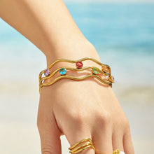 Gold clear cubic zirconia open bangle styled on the wrist