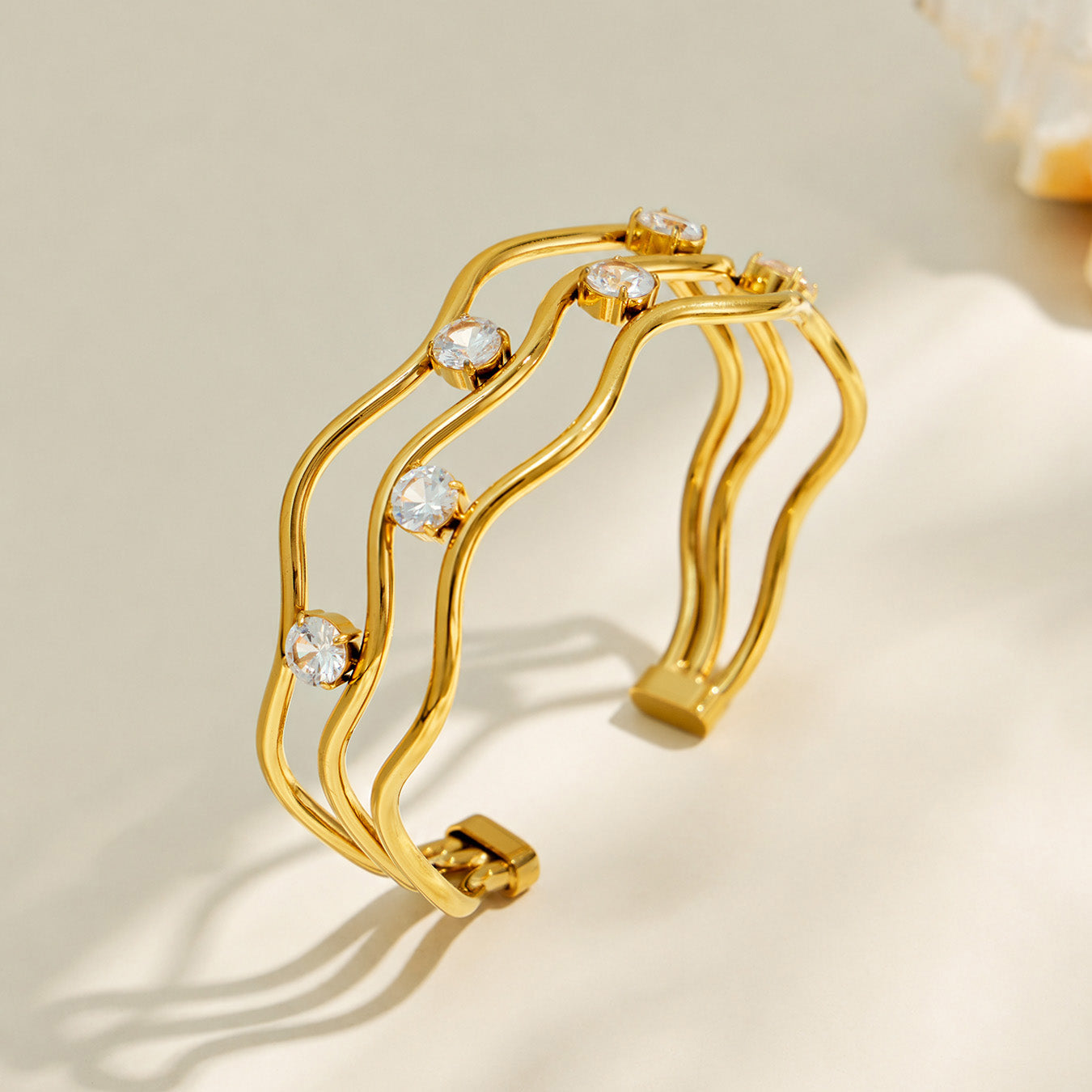 Gold three-layer open bangle with clear cubic zirconia accents