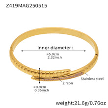 Gold-tone clear zircon nail bangle with a 5.9 cm inner diameter and 21.6 g weight
