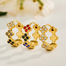 Gold four-leaf clover earrings displayed in white, multicolor and black CZ styles