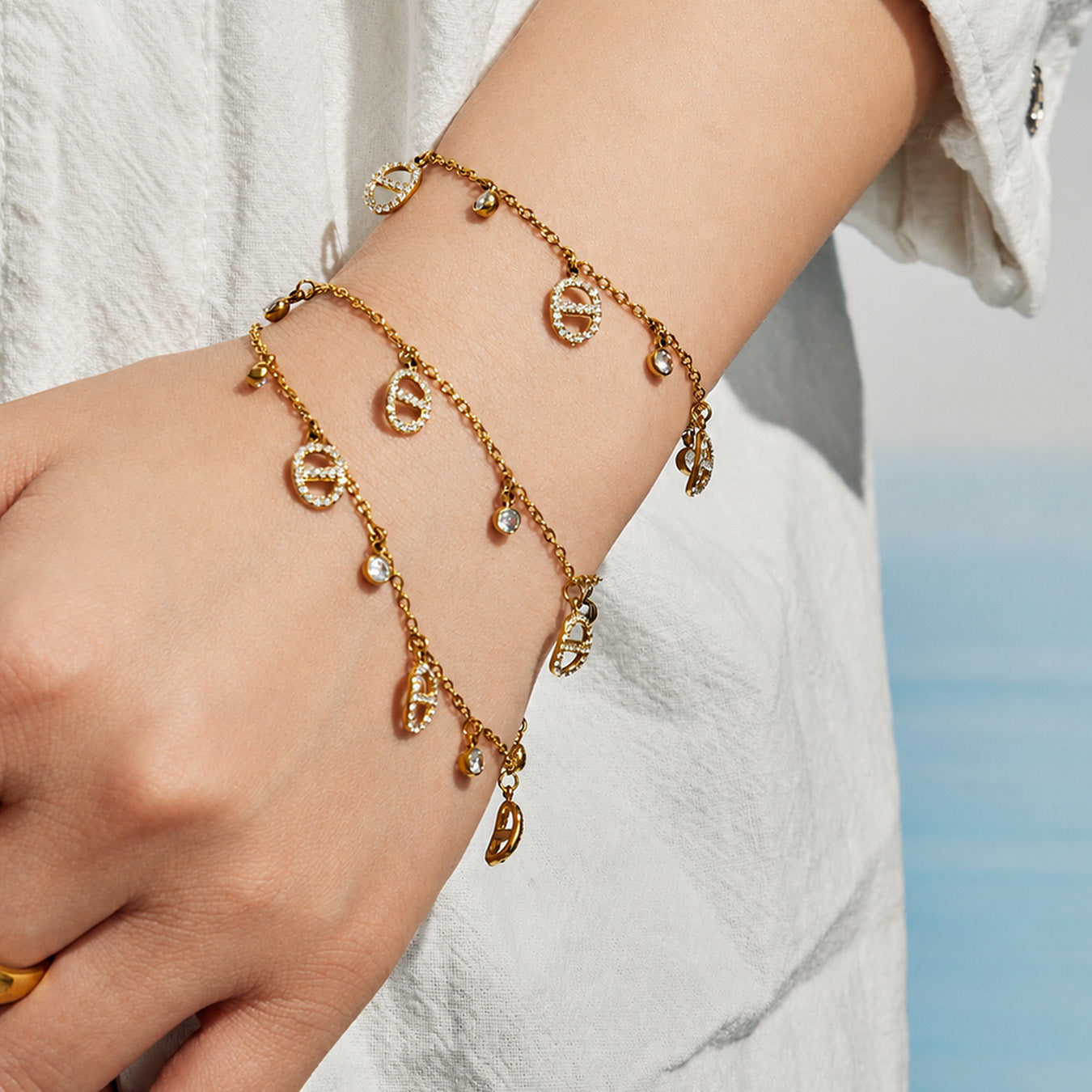 close up of gold coin charm bracelet and ring waterproof stainless steel jewelry set