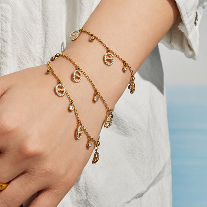 close up of gold coin charm bracelet and ring waterproof stainless steel jewelry set