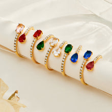 Gold-tone colorful glass open rings with white CZ accents displayed across fingers