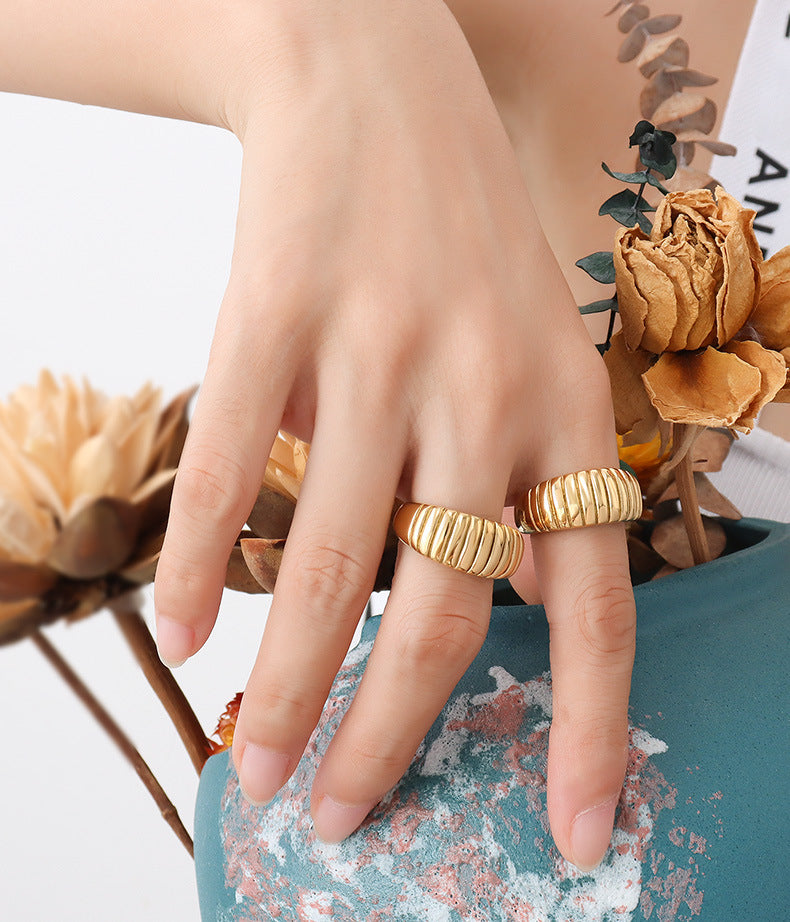 Gold croissant ribbed rings styled with dried flowers for boutique fashion jewelry and gift ring displays