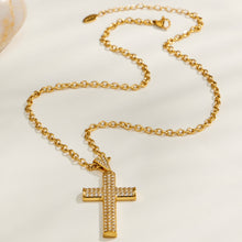 Gold cross chain necklace flat lay