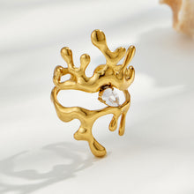Gold 316L stainless steel branching sculptural ring with cubic zirconia accent on a light background