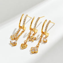 Gold-tone stainless steel CZ flower and butterfly drop earrings displayed together