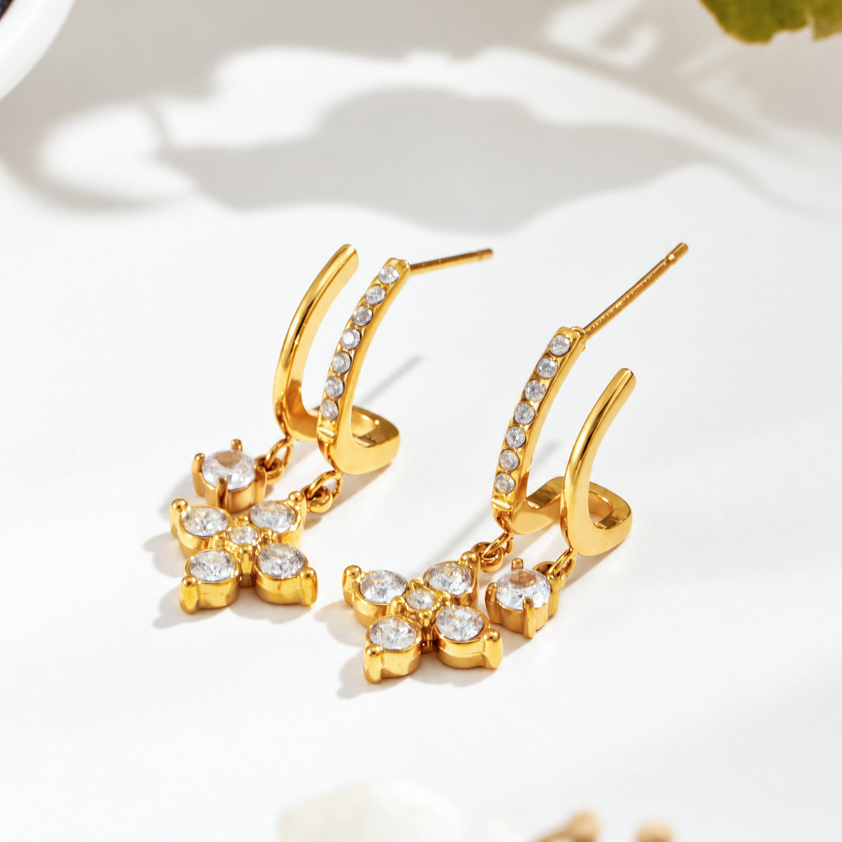 Gold-tone stainless steel flower CZ drop earrings displayed as a pair