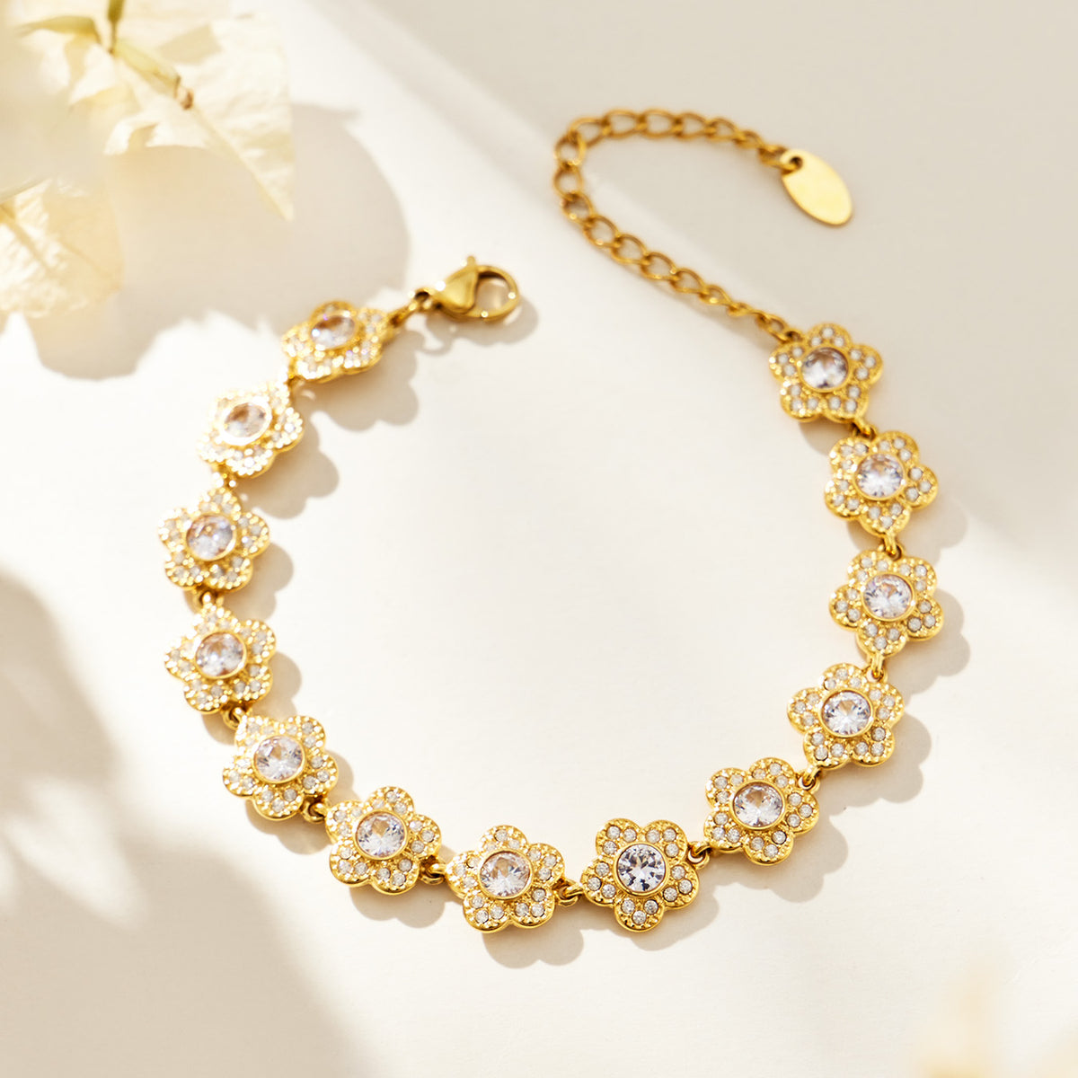 Gold-tone stainless steel flower link bracelet with cubic zirconia accents