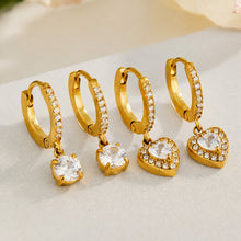 Gold cubic zirconia huggie earrings displayed in heart and round charm styles